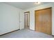 This bedroom features neutral carpet and a double door closet at 29762 Spruce Rd, Evergreen, CO 80439