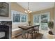 Cozy dining area features a chandelier, natural light, and access to the outdoor space at 29762 Spruce Rd, Evergreen, CO 80439