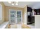 Dining area with access to the outdoors and a stainless steel fridge in the kitchen at 29762 Spruce Rd, Evergreen, CO 80439
