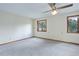 Spacious and vacant bedroom featuring plush carpeting, bright neutral walls, and natural light at 29762 Spruce Rd, Evergreen, CO 80439