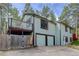 Angled view of a two story home with two-car garage and balcony at 29762 Spruce Rd, Evergreen, CO 80439