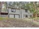 Two story home with attached 2 car garage, upper deck and situated amongst mature trees at 29762 Spruce Rd, Evergreen, CO 80439
