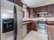 Kitchen with stainless steel appliances, dark wood cabinetry, and tile flooring at 29762 Spruce Rd, Evergreen, CO 80439