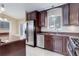 Kitchen with granite countertops, tile backsplash, stainless steel appliances and dark wood cabinets at 29762 Spruce Rd, Evergreen, CO 80439