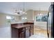 View of kitchen with countertop, dark wood cabinets and stainless steel refrigerator at 29762 Spruce Rd, Evergreen, CO 80439