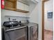 The laundry room contains shelving above the machines and brick flooring at 29762 Spruce Rd, Evergreen, CO 80439