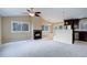Spacious living room featuring a fireplace and large windows offering lots of natural light at 29762 Spruce Rd, Evergreen, CO 80439