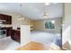 Open-concept living area with a fireplace, seamlessly connecting to the kitchen for modern living at 29762 Spruce Rd, Evergreen, CO 80439