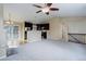 Living room with staircase, dark wood cabinets, stainless steel appliances and view of sliding glass doors at 29762 Spruce Rd, Evergreen, CO 80439