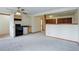 Open living space featuring a kitchenette, neutral walls, plush carpet, and neutral color palette at 29762 Spruce Rd, Evergreen, CO 80439