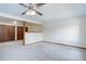 Spacious living area with neutral carpeting, bright walls, and closet space at 29762 Spruce Rd, Evergreen, CO 80439