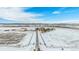 Aerial view of home with long driveway and solar panels, in winter setting at 4075 Merada Ct, Franktown, CO 80116