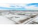 Stunning aerial view of a large estate on expansive acreage in a snow-covered landscape with mountain views at 4075 Merada Ct, Franktown, CO 80116