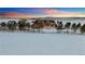 Wide aerial view of attractive home on a large lot featuring mature trees and a white perimeter fence at twilight at 4075 Merada Ct, Franktown, CO 80116