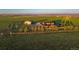 A beautiful farm with a tan house and a big green yard at 4075 Merada Ct, Franktown, CO 80116