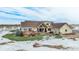 Rear view of home featuring an outdoor deck with furniture, fire pit, and grassy lawn at 4075 Merada Ct, Franktown, CO 80116
