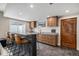 Basement wet bar with dark cabinetry, quartz countertop, and seating at 4075 Merada Ct, Franktown, CO 80116