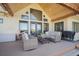 Relaxing covered patio with comfortable seating and stylish decor, perfect for outdoor living at 4075 Merada Ct, Franktown, CO 80116