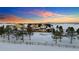 Scenic aerial view captures a charming home embraced by snow-covered landscaping and an expansive open field at 4075 Merada Ct, Franktown, CO 80116