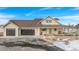 Ranch home with a three-car garage, covered porch, and snow covered front yard at 4075 Merada Ct, Franktown, CO 80116