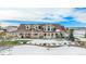 A spacious property with covered porch and manicured landscaping in a snow covered scene at 4075 Merada Ct, Franktown, CO 80116