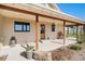 Welcoming covered porch with rustic wood columns and decorative accents, enhancing curb appeal at 4075 Merada Ct, Franktown, CO 80116