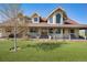 Stunning two-story home featuring a well manicured lawn and a welcoming front porch at 4075 Merada Ct, Franktown, CO 80116