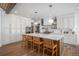 Bright kitchen with a spacious island, modern lighting, and stainless steel appliances for culinary enthusiasts at 4075 Merada Ct, Franktown, CO 80116
