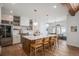 Well-lit kitchen boasts a large island with seating, stainless steel appliances, and stylish pendant lighting at 4075 Merada Ct, Franktown, CO 80116
