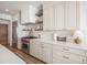Well-appointed kitchen with stainless steel appliances, white cabinets, quartz countertops, and tile backsplash at 4075 Merada Ct, Franktown, CO 80116