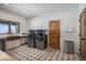 Spacious laundry room with modern washer and dryer units, a stylish sink, and ample storage space at 4075 Merada Ct, Franktown, CO 80116