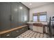 Laundry room with custom cabinetry, a copper sink, and built-in bench at 4075 Merada Ct, Franktown, CO 80116