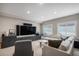 Inviting living room with plush seating, modern entertainment center, and bright windows for natural light at 4075 Merada Ct, Franktown, CO 80116