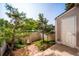 Small backyard with pine trees, stone path, and a shed with a door at 9621 W Chatfield Ave # F, Littleton, CO 80128