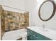 Bathroom with tiled shower over tub, modern vanity with sink, and large mirror at 9621 W Chatfield Ave # F, Littleton, CO 80128