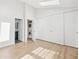 Bedroom features wood floors, a closet, and is adjacent to the laundry room at 9621 W Chatfield Ave # F, Littleton, CO 80128