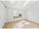 This bedroom has wood floors, natural light from the skylights, and a closet at 9621 W Chatfield Ave # F, Littleton, CO 80128