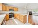 Efficient kitchen with breakfast bar, stainless steel appliances, and open flow to living area at 9621 W Chatfield Ave # F, Littleton, CO 80128