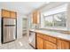 Practical kitchen with stainless steel appliances, ample cabinetry, and natural light at 9621 W Chatfield Ave # F, Littleton, CO 80128