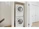 This laundry area contains a stacked washer and dryer set, and is adjacent to a closet at 9621 W Chatfield Ave # F, Littleton, CO 80128