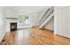 Cozy living room with a fireplace, hardwood floors, and a staircase leading to the upper level at 9621 W Chatfield Ave # F, Littleton, CO 80128