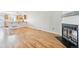 Bright living room featuring hardwood floors, fireplace, and seamless flow to the kitchen at 9621 W Chatfield Ave # F, Littleton, CO 80128