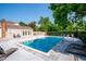 This community pool has lounge chairs, a building, and nice landscaping at 9621 W Chatfield Ave # F, Littleton, CO 80128