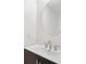 This powder room features a modern sink, vanity and fixtures, and a round mirror at 9621 W Chatfield Ave # F, Littleton, CO 80128