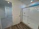 Bathroom with glass enclosed shower, a view of a bedroom, and modern fixtures at 22023 E 38Th Pl, Aurora, CO 80019