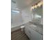 Bathroom featuring granite vanity, soaking tub with tile surround, and modern lighting at 22023 E 38Th Pl, Aurora, CO 80019