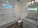 Bright bathroom with a tub and shower combination and a vanity with a granite countertop at 22023 E 38Th Pl, Aurora, CO 80019
