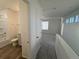 Bright bathroom and bedroom space featuring wood-look floors and neutral carpet at 22023 E 38Th Pl, Aurora, CO 80019