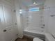 Clean bathroom with a white tub and shower combination and ample storage space at 22023 E 38Th Pl, Aurora, CO 80019