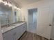 Bathroom featuring dual sinks, granite countertops, and a view into the bedroom at 22023 E 38Th Pl, Aurora, CO 80019